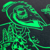 Close crop of the green crow illustration on black cotton