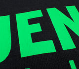 Close crop of green display type on black cotton